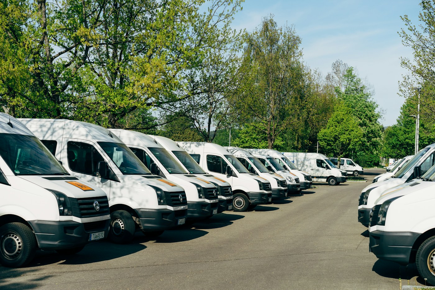 A fleet of white commercial vans parked together